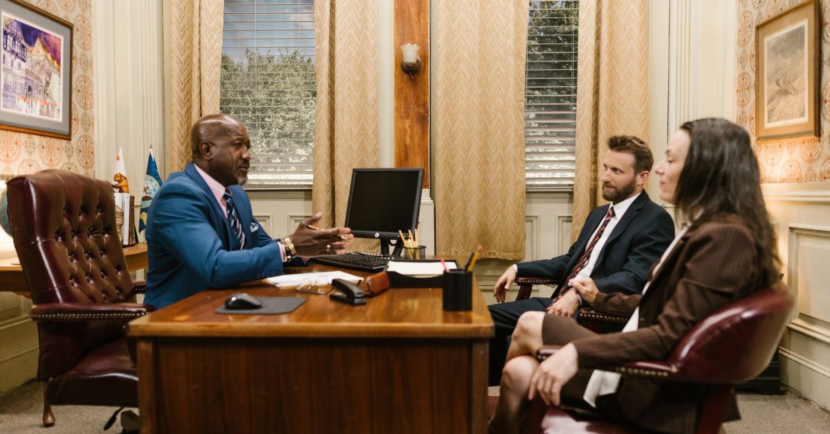 Attorney consulting with clients at a desk