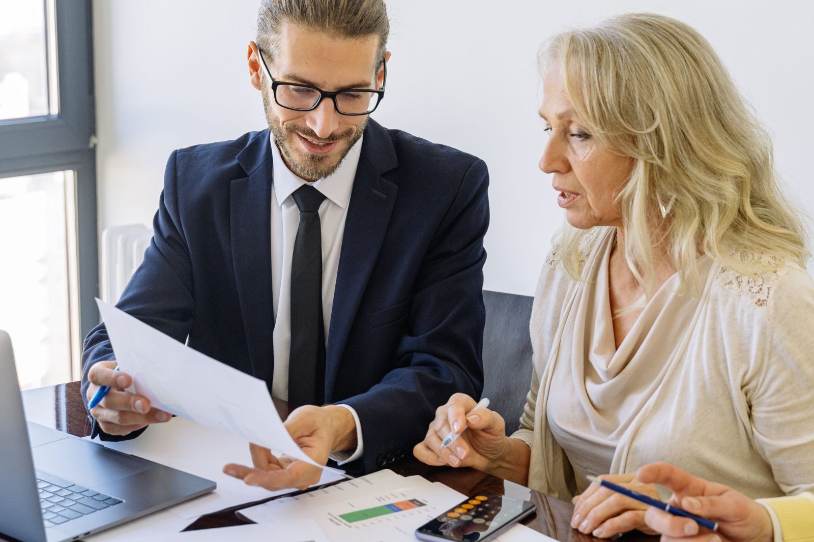 Attorney in a suit reviewing a document with a client