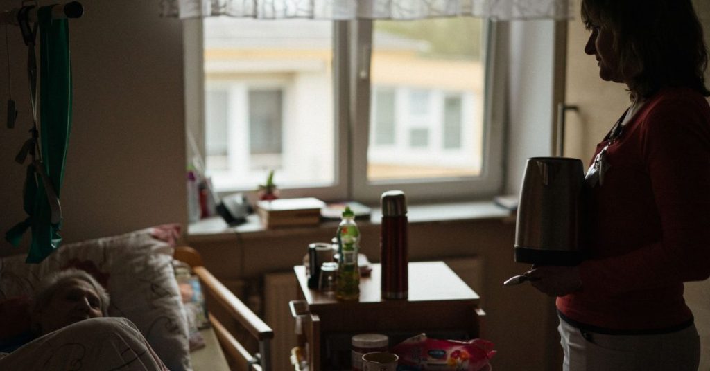 Caregiver preparing a drink for a senior at home