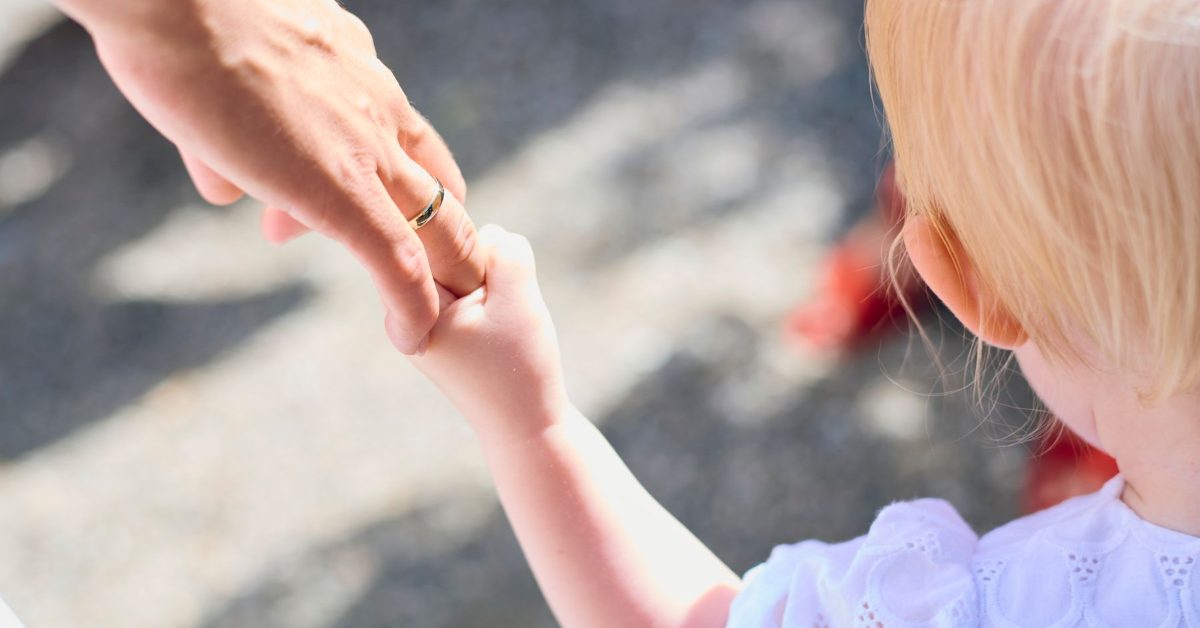 Child holding a parent hand