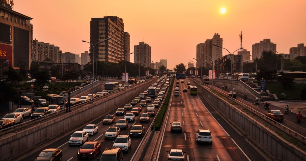 Cars in heavy traffic on a city highway at sunset