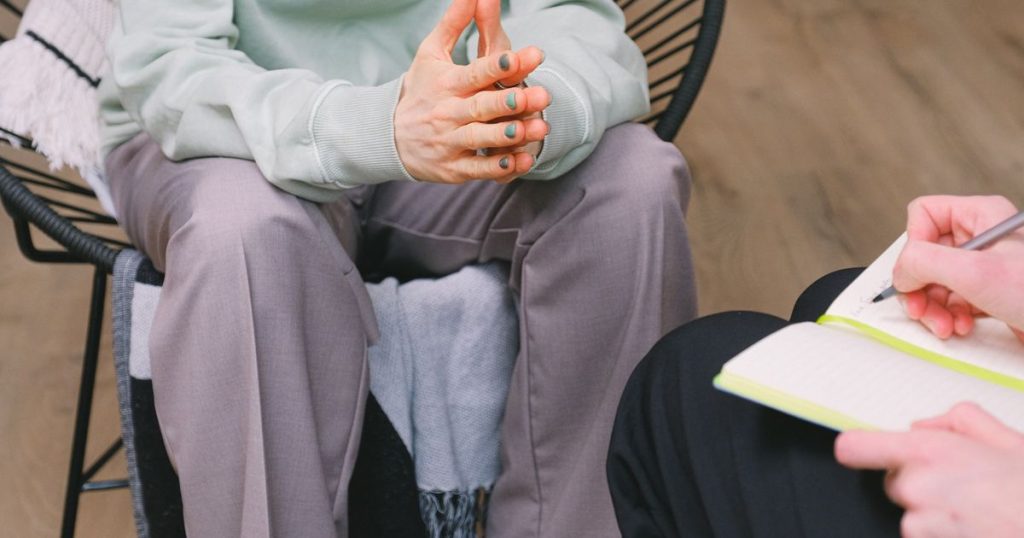 A counselor talking with a client during a mental health session