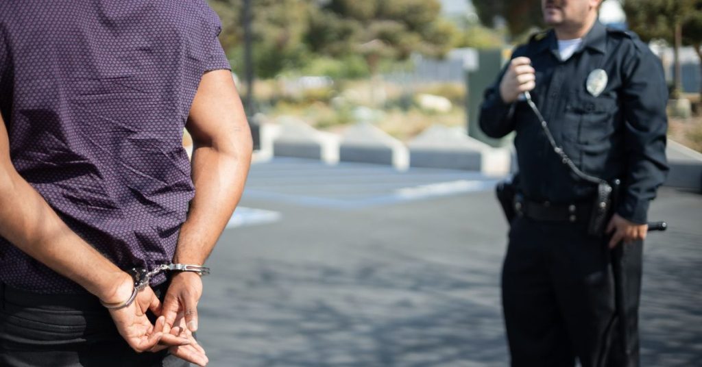 Officer with a handcuffed man