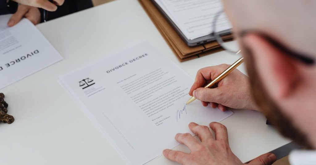Person signing a divorce document