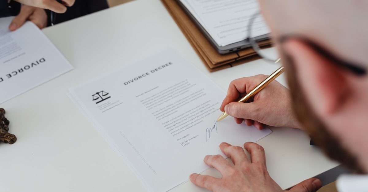 Person signing a divorce document